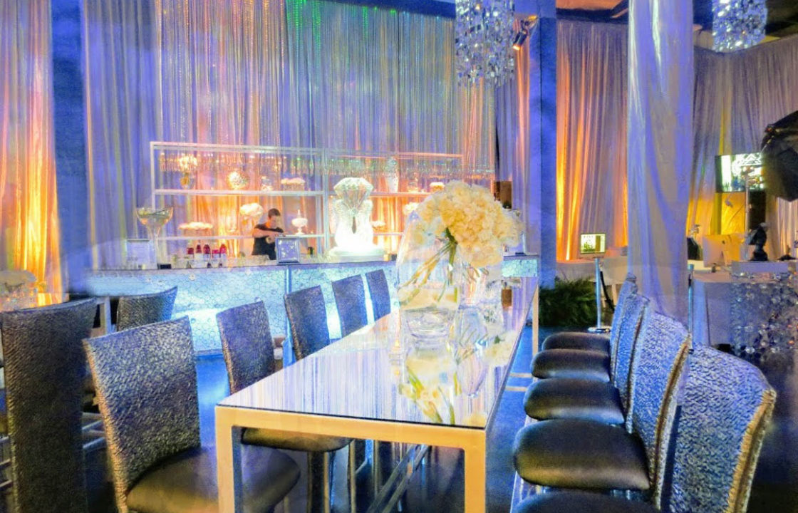 Silver wedding venue with flowers and bar