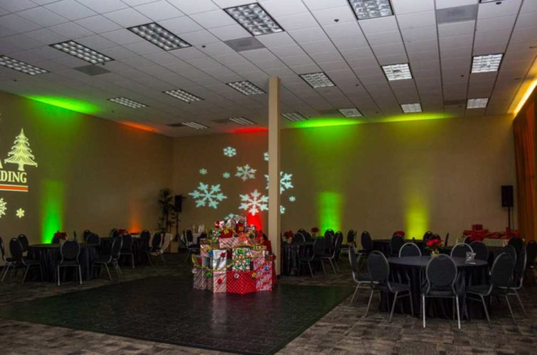 Holiday event with gift decorations, snowflakes and Christmas tree projections