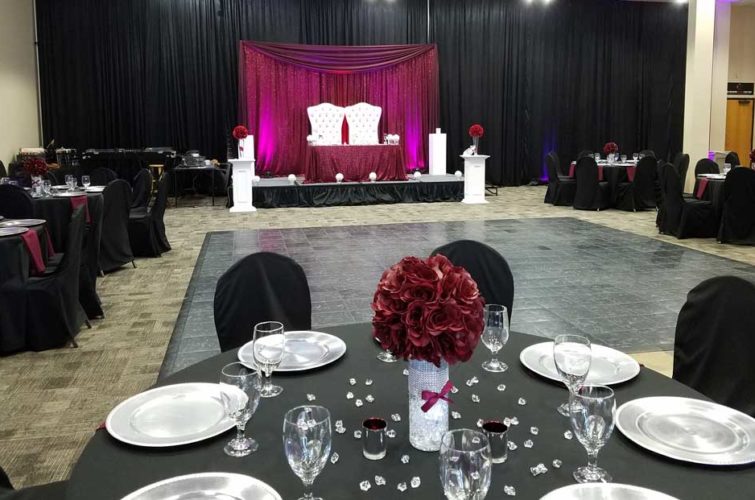 Wedding reception with banquet tables and red flowers