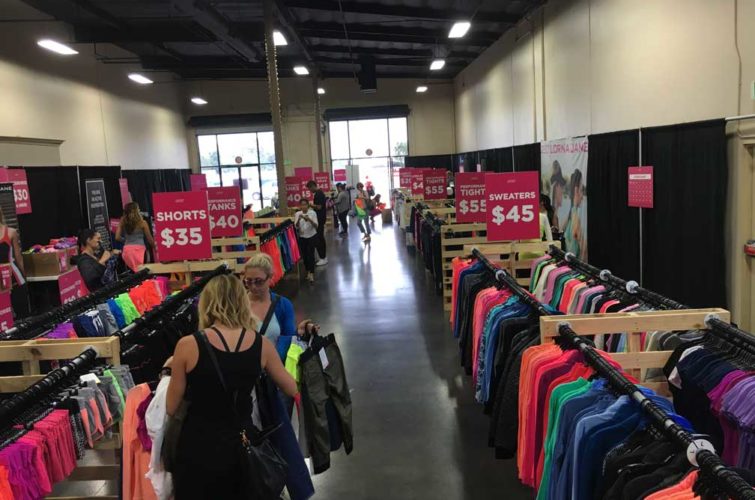 Sample sale with racks of clothes and women shopping