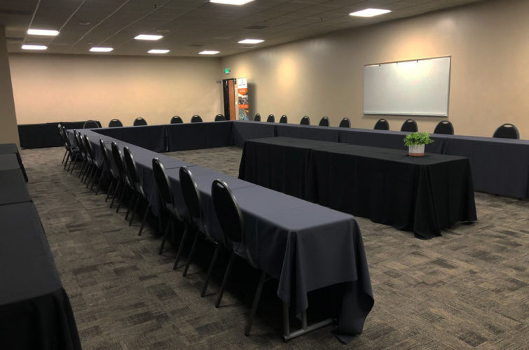 presentation room with tables, whiteboard, and chairs
