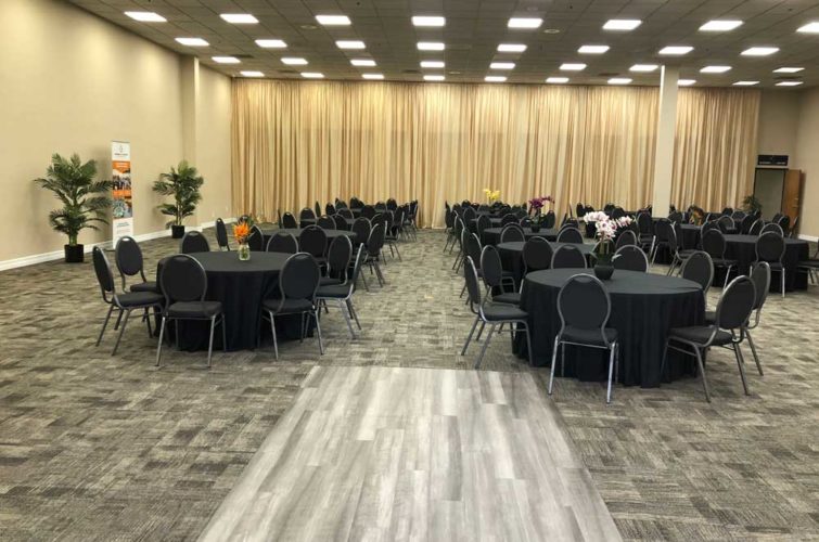 event space with tables, chairs, and flower centerpieces