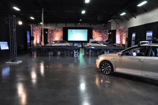 cars and tables setting at Volkswagen 2013 Jetta Hybrid Release