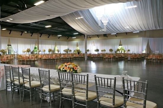 tables, chairs, and flowers setting for the wedding event