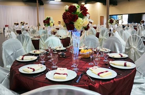 tables, chairs, plates and flowers setting for the wedding event
