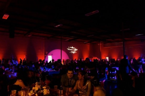 people sitting at the table in the dark at the wedding event
