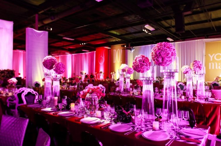 flowers and plates setting on the tables with chairs at TSE Wedding Gala 2015