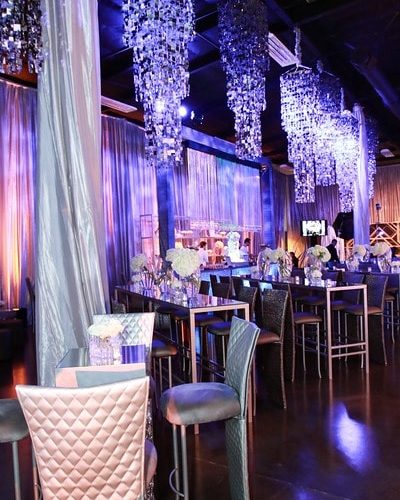 tables and chairs setting with chandelier lighting at TSE Wedding Gala 2015