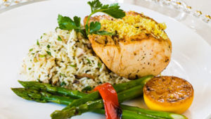 Salmon with rice and vegetables on a white plate