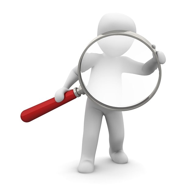 Someone looking for a job. Holding a magnifying glass searching for a job. 