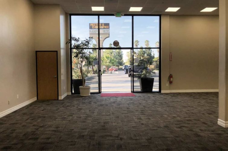 open doors that lead to the outside of business expo center with freeway sign