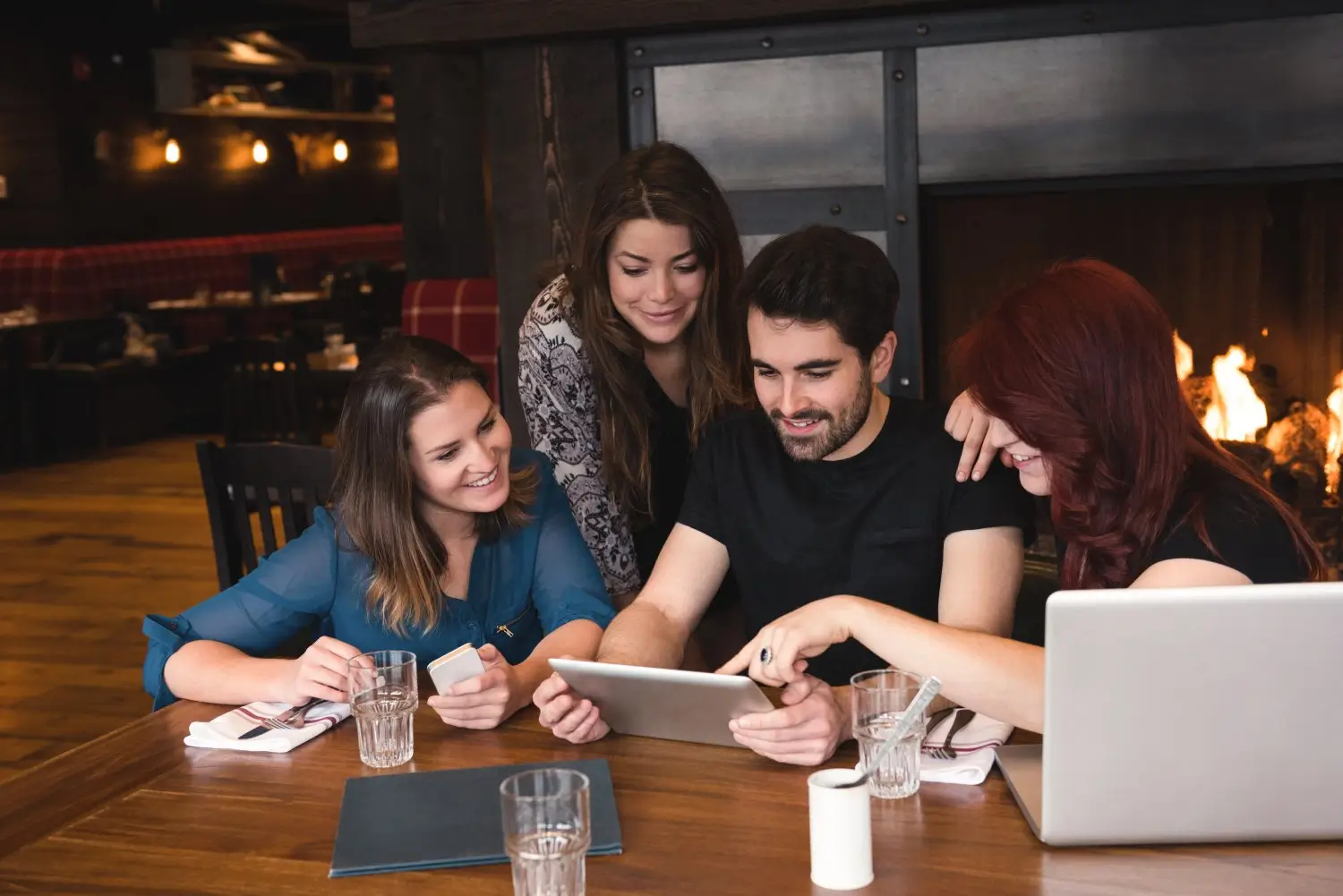 friends-using-digital-tablet-bar